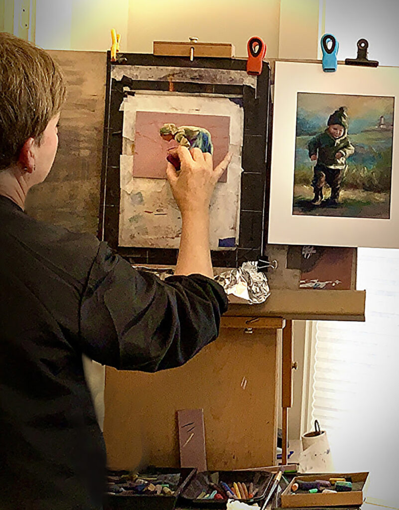 Anne working with pastels in her studio